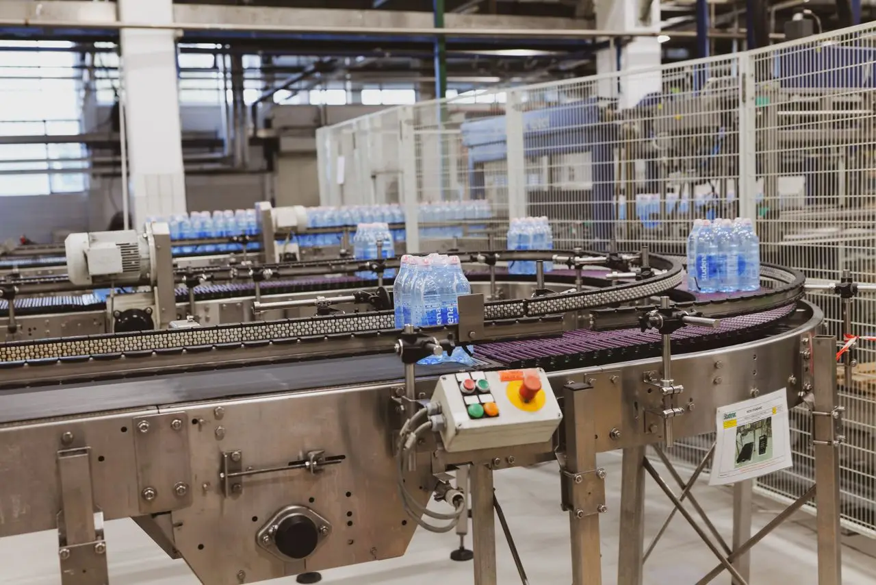 Bottled water packs moving along a factory conveyor